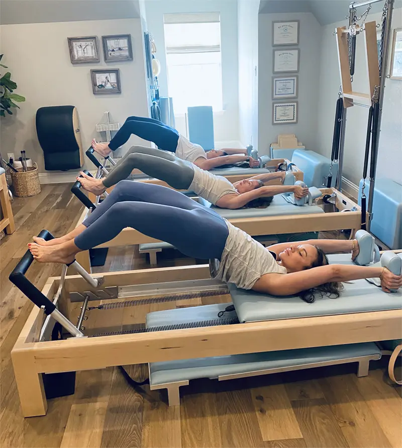 Women performing a Semicircle exercise on the Reformer at Authentic Pilates in Aledo