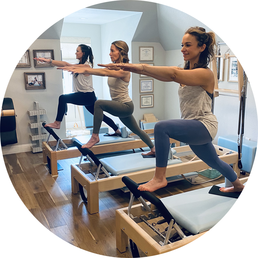 trio of women performing a Lunge exercise on the reformer in a classical Pilates studio in Aledo/Willow Park