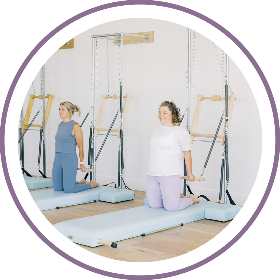 Happy women doing an exercise on the Tower during a beginner Pilates class