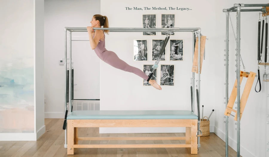 Woman exercising on Pilates cadillac